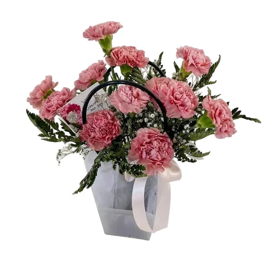 Carnation arrangement in a stylish flower basket