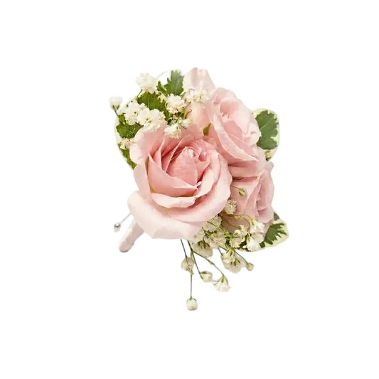 Floral Boutonniere arrangement with pink roses and greenery on a white background