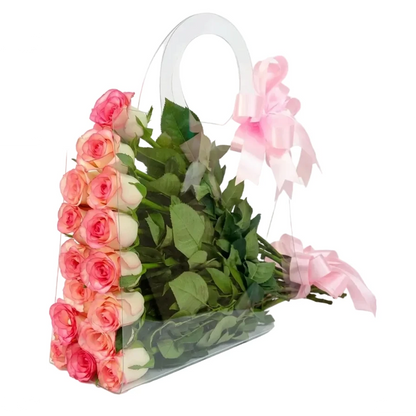 Bouquet of pink and white roses in a clear plastic bag with pink ribbons on a white background