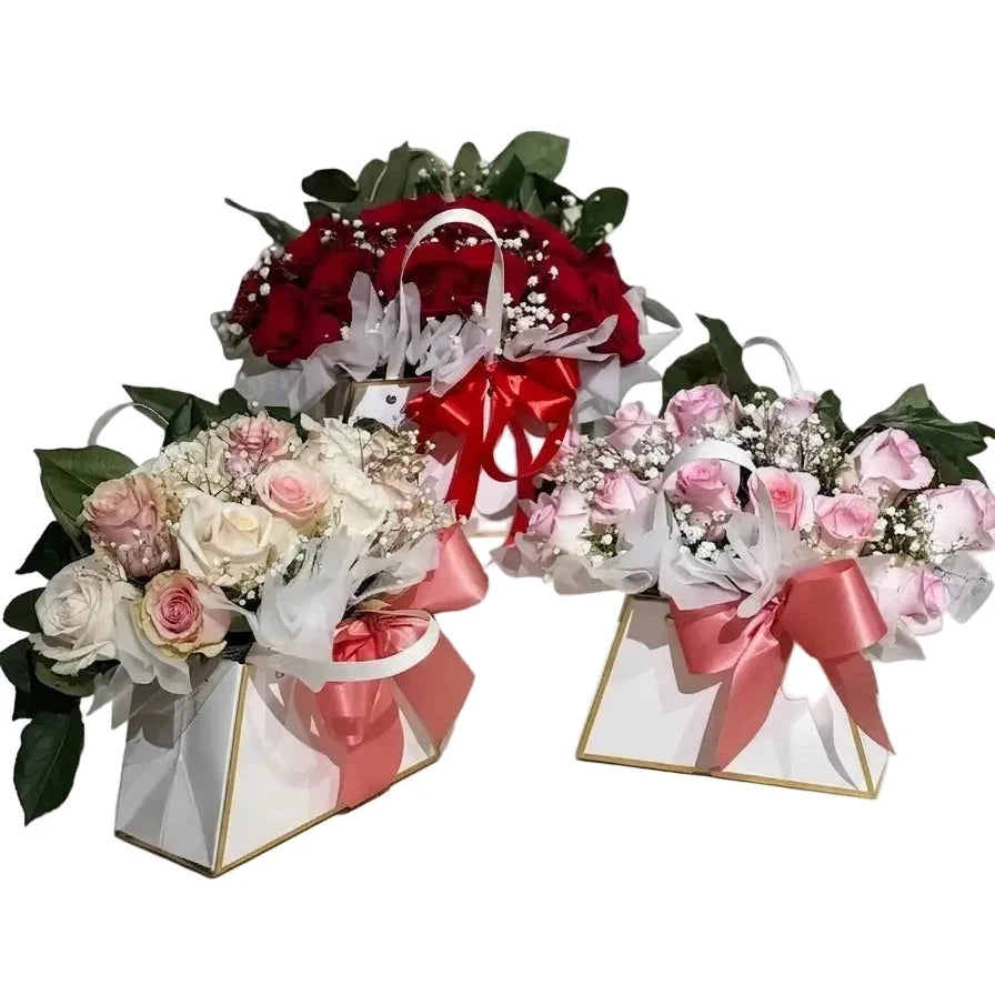 Three flower bouquets with ribbons on a white background