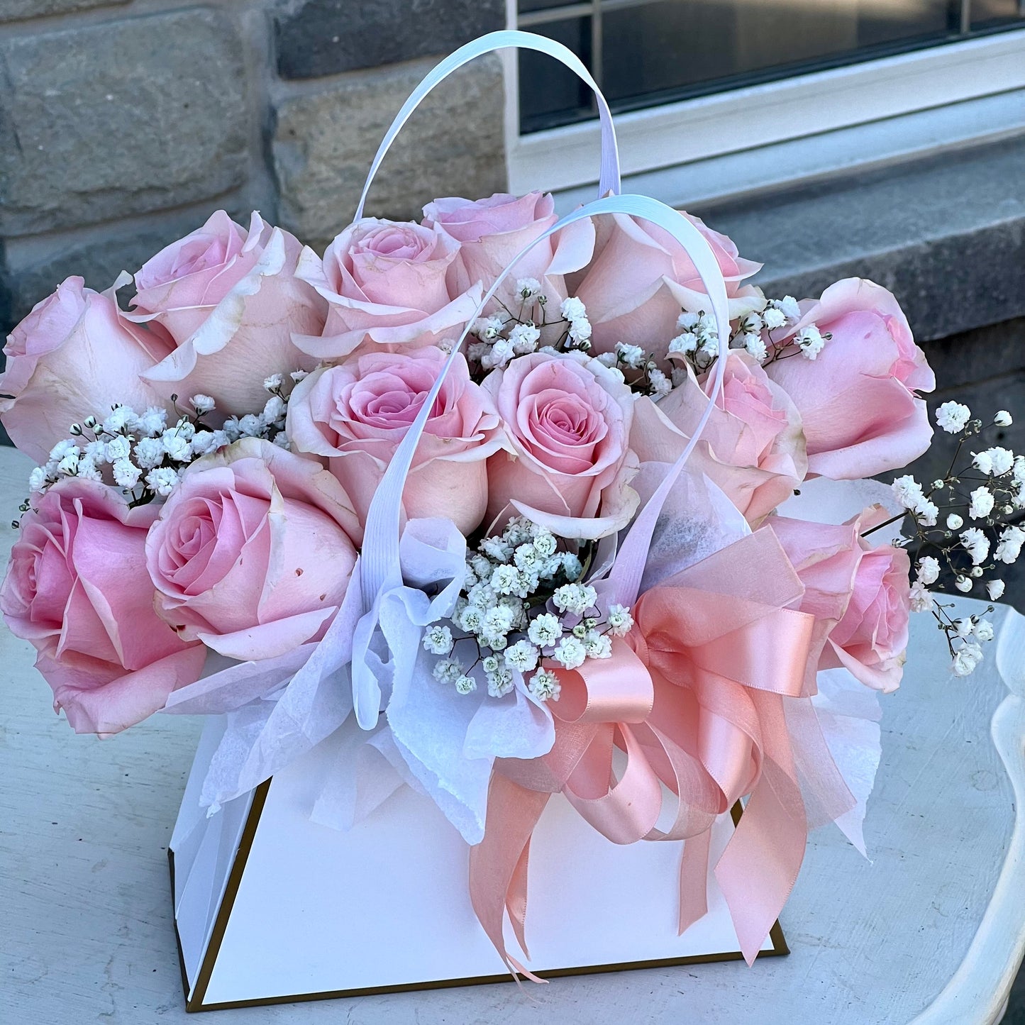 Dozen Pink Rose arrangement in a package