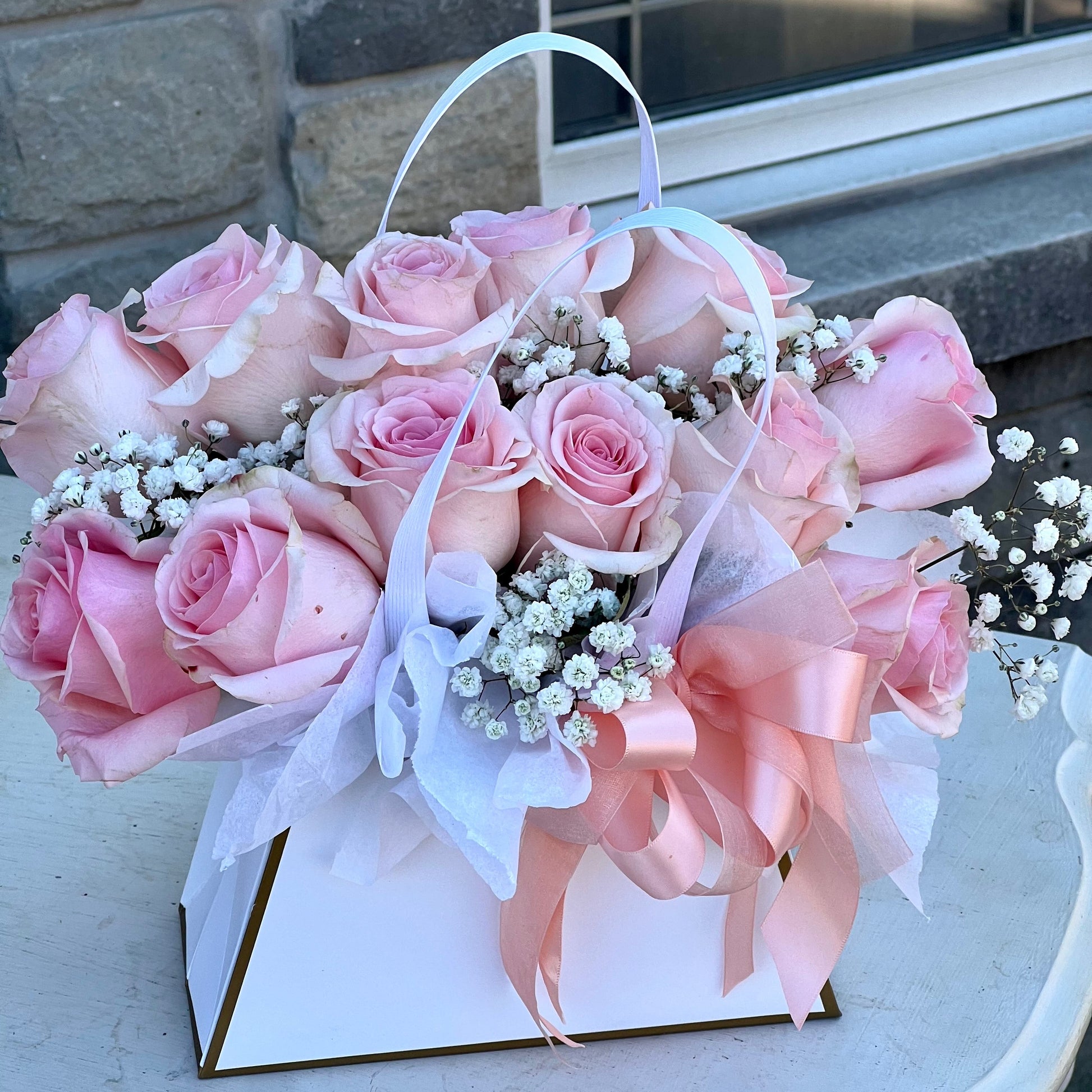Dozen Pink Rose arrangement in a package