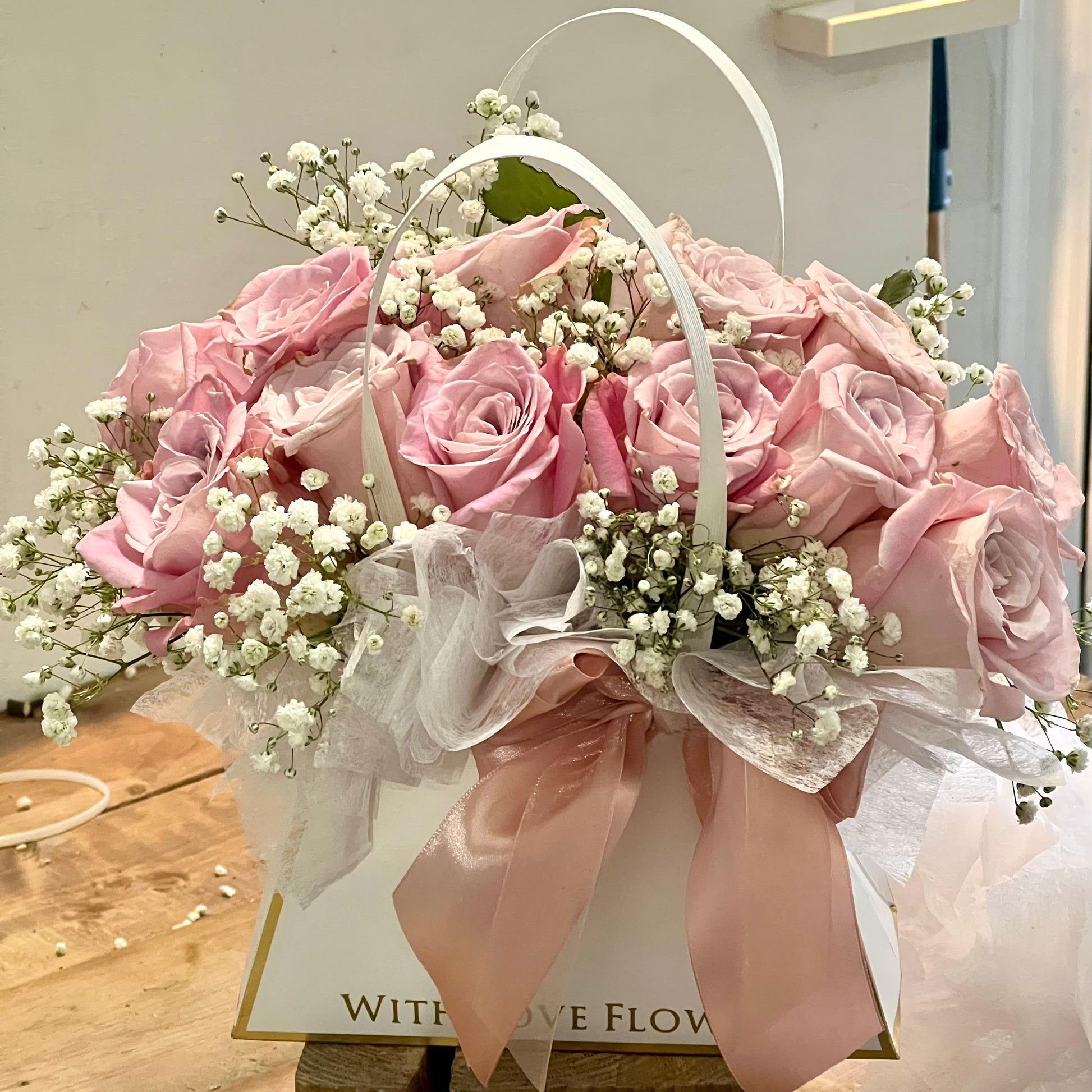 Dozen Pink Roses in a bag shaped arrangement 