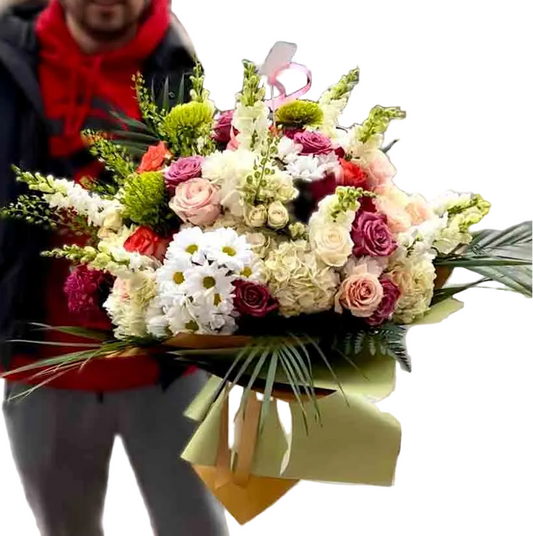 Person holding a large bouquet of flowers on a white background