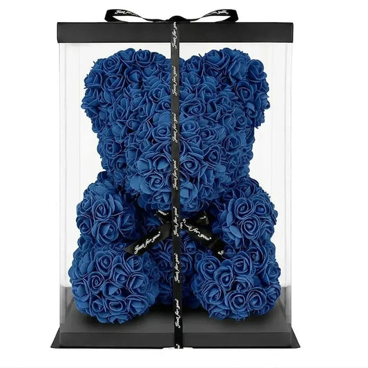 A large blue rose teddy bear gift box with a clear acrylic body, black base, black lid, and a black ribbon bow, shown on a plain white background.