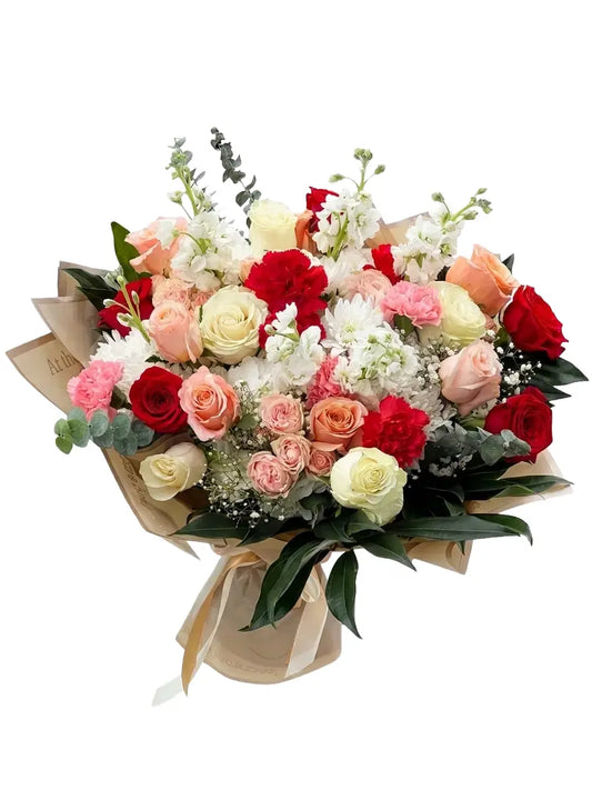 Bouquet of red, white, and pink flowers with greenery on a white background