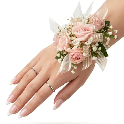 Hand wearing a floral wrist corsage on a white background