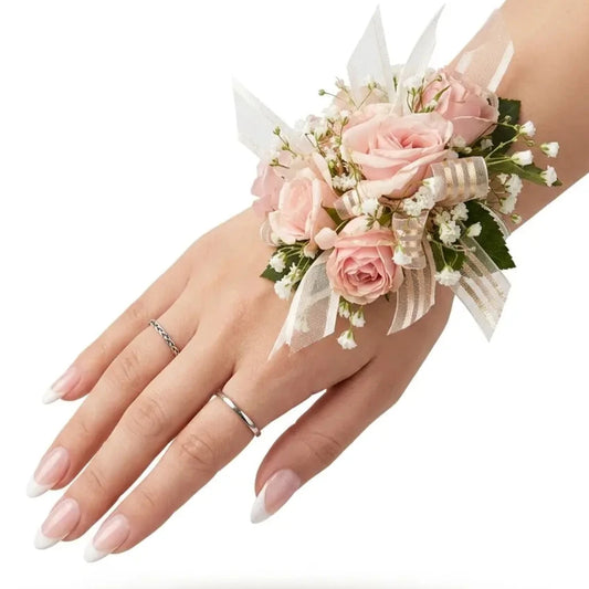 Hand wearing a floral wrist corsage on a white background
