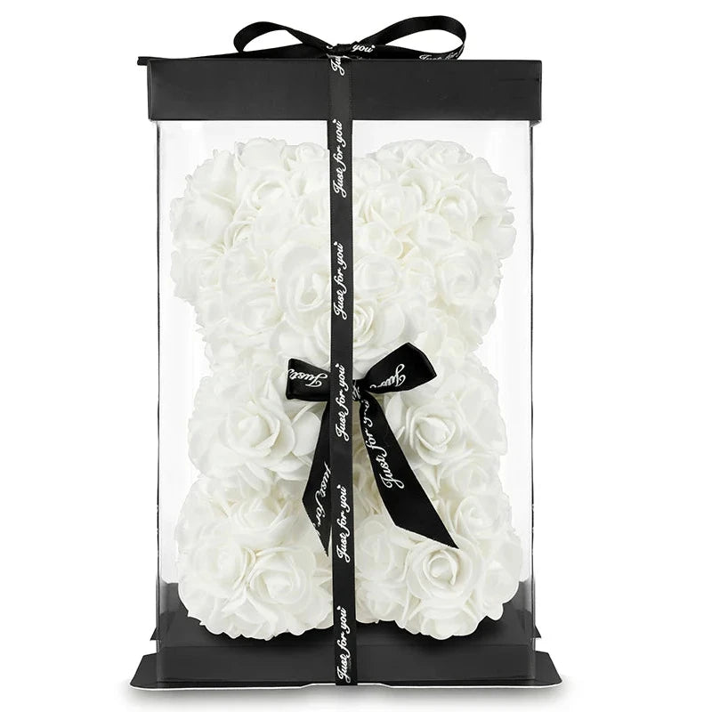 White rose bear in a clear packaging with black ribbon and tag on a white background